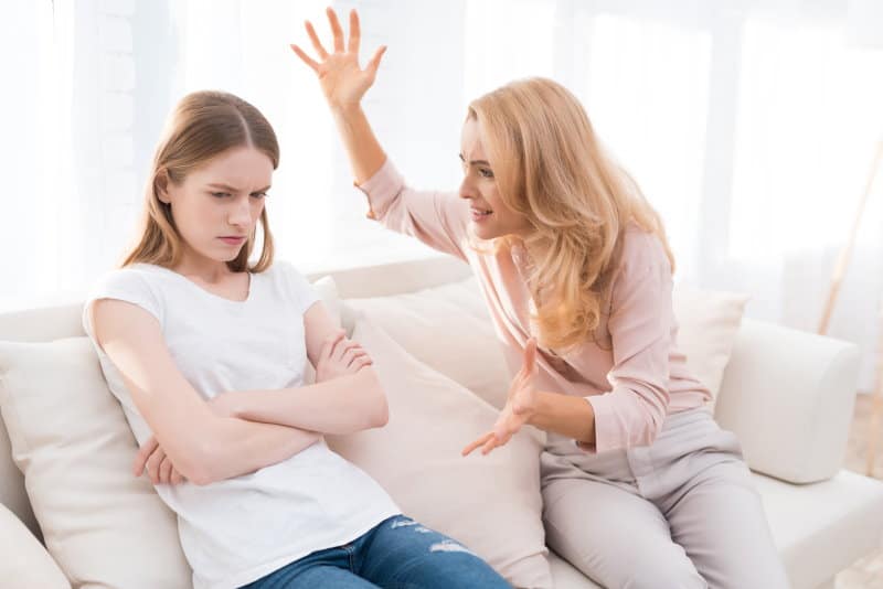 Mom and a teenage daughter are arguing with each other.